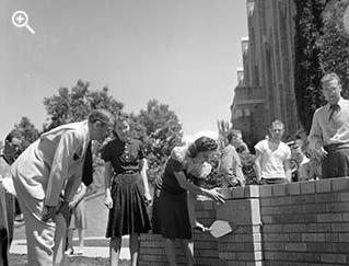 Student adding plaque on the Hi Bridge