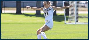 Number 37 women's soccer athlete kicking the ball down the field.