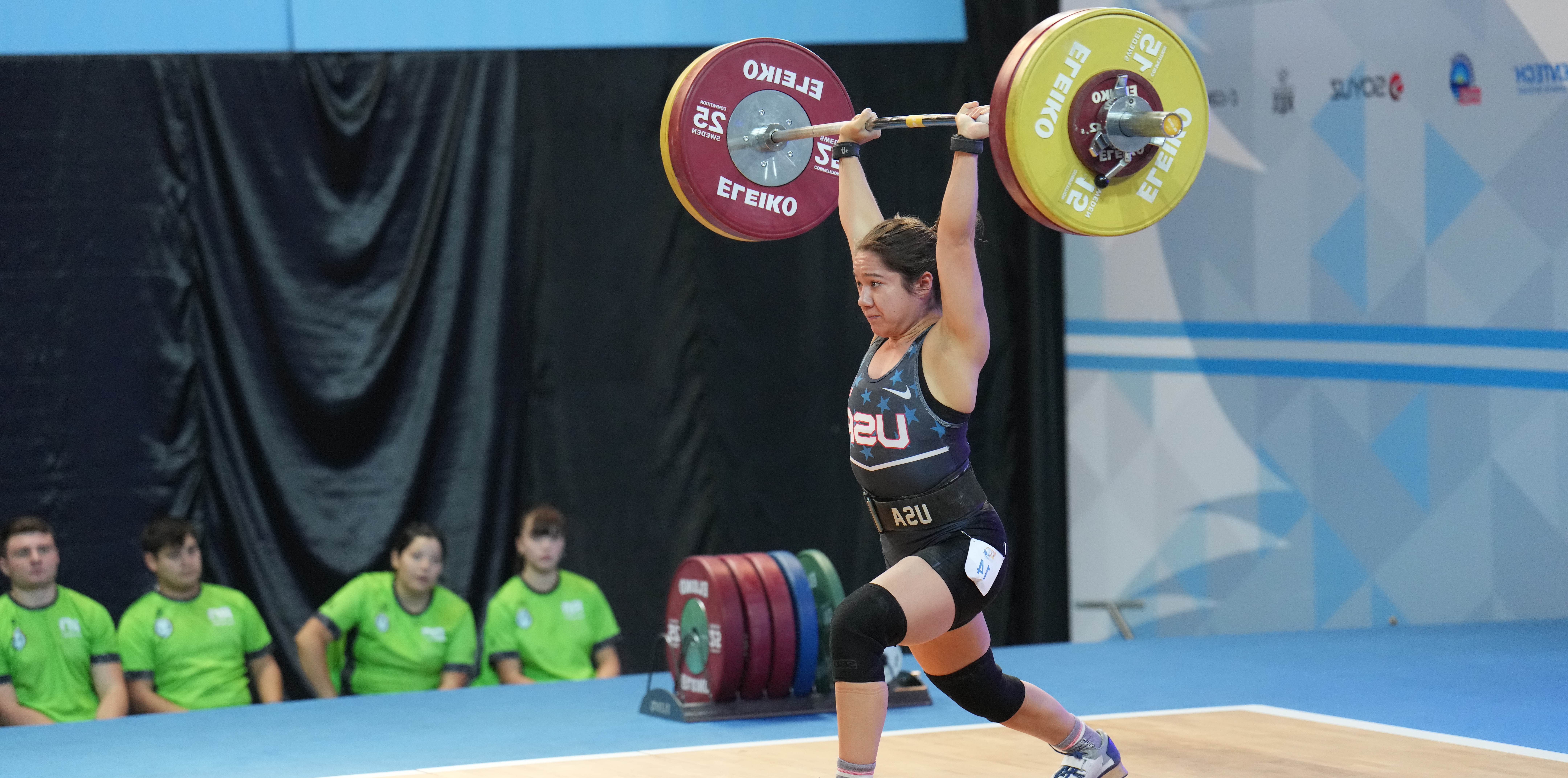 Jourdan Delacruz lifting a ton of weight over her head